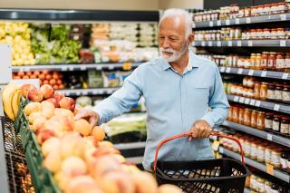 Senior grocery shopping in the produce aisle