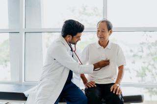 Doctor checking the heart health of a senior patient