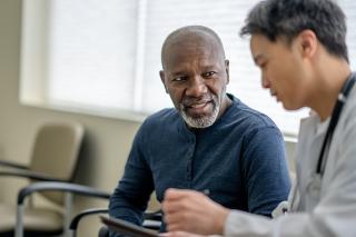 A senior patient is speaking with their pcp about their test and screenings
